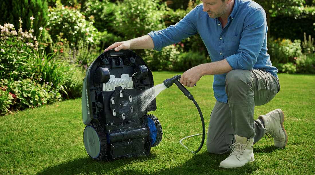 Man Cleaning Lawn Robot